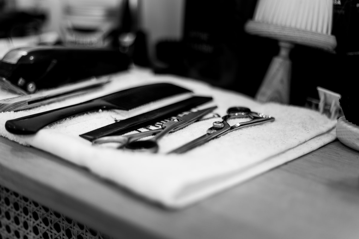 Barber scissors and comb resting on a fresh towel