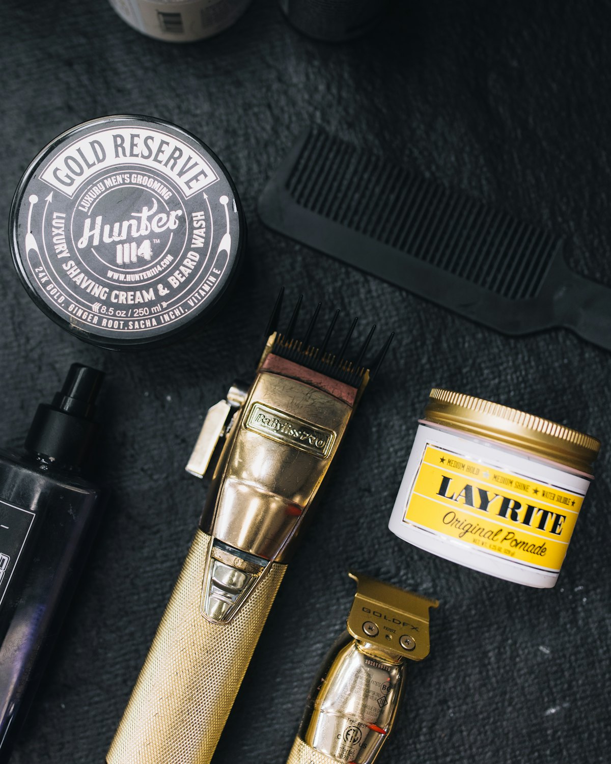 A barber's clippers, comb and grooming kit laid out